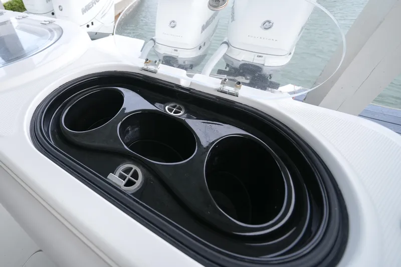 Catallac Yacht Photos Pics Cup holders on 2023 Invincible 46 Catamaran, with outboard motors in the background.