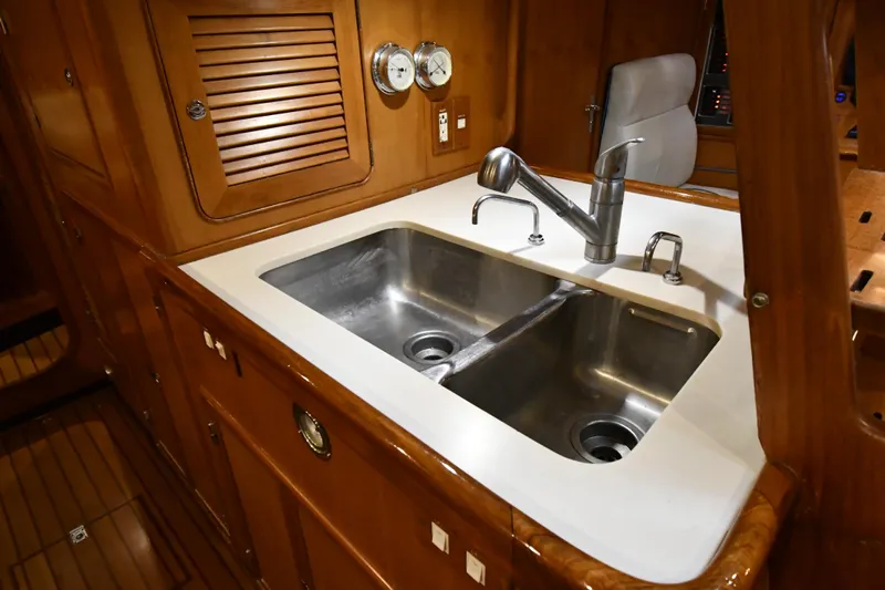 Matilida Yacht Photos Pics Double sink in a 2002 Hylas 46 yacht's wooden interior galley.