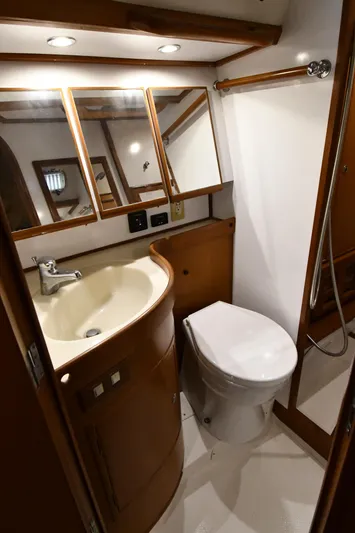 Matilida Yacht Photos Pics Bathroom interior of a 2002 Hylas 46 yacht with sink, toilet, and mirrors.