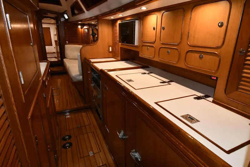 Matilida Yacht Photos Pics Luxurious wooden interior of a 2002 Hylas 46 yacht, featuring a well-equipped galley.