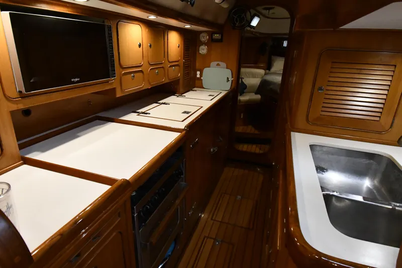 Matilida Yacht Photos Pics Luxurious interior of a 2002 Hylas 46 yacht with modern kitchen amenities.