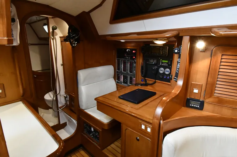 Matilida Yacht Photos Pics Interior of 2002 Hylas 46 yacht with navigation station and wooden cabinetry.