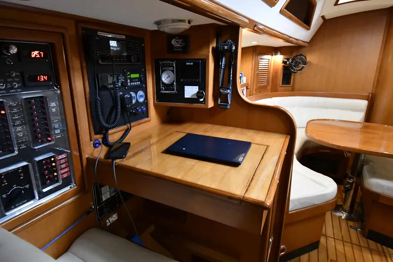 Matilida Yacht Photos Pics Interior of 2002 Hylas 46 yacht with navigation station and seating area.