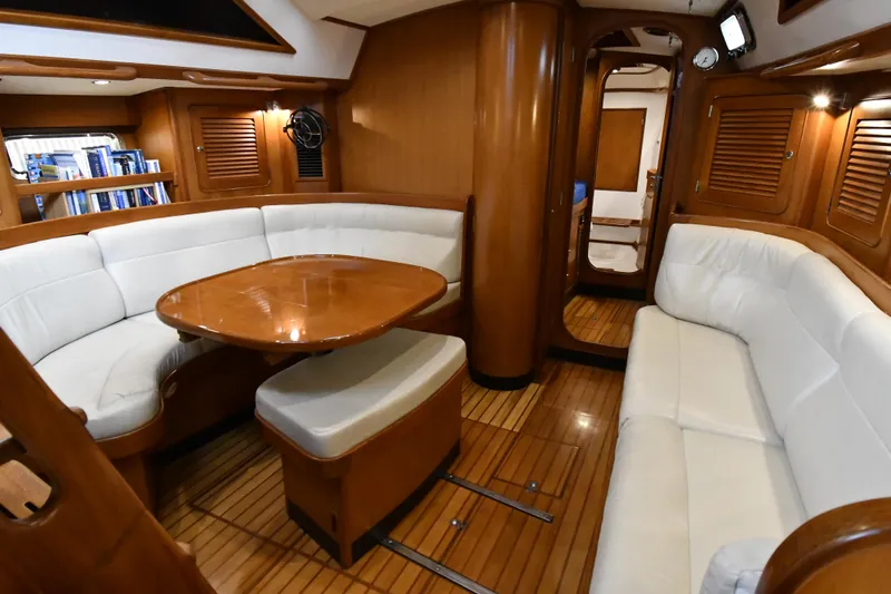 Matilida Yacht Photos Pics Luxurious interior of a 2002 Hylas 46 yacht with elegant wood and white seating.