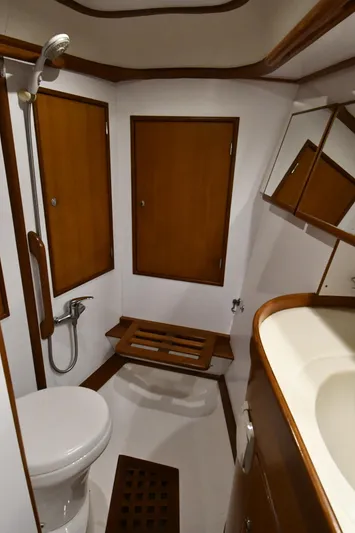 Matilida Yacht Photos Pics 2002 Hylas 46 yacht bathroom with wooden cabinets and modern fixtures.