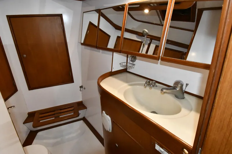 Matilida Yacht Photos Pics Bathroom interior of 2002 Hylas 46 yacht with wooden cabinetry and sink.