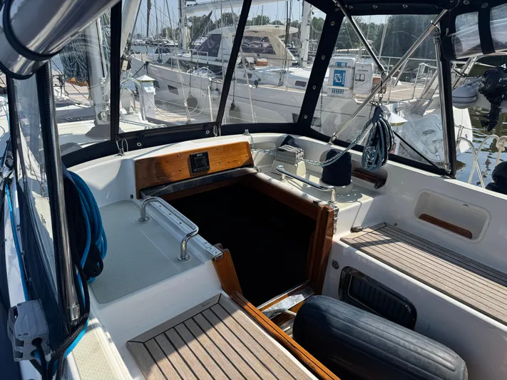 Matilida Yacht Photos Pics Cockpit of a 2002 Hylas 46 sailboat, featuring wood accents and marina view.