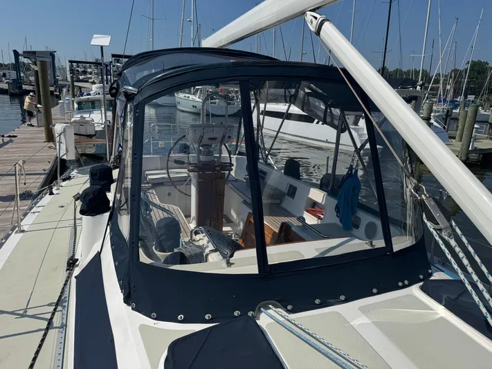 Matilida Yacht Photos Pics Sailboat Hylas 46, 2002 model, docked at marina with clear cockpit enclosure.