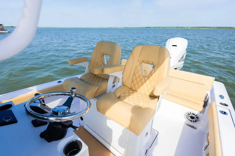 Yacht Photos Pics Manufacturer Provided Image: 2025 Sportsman Masters 267 Bay Boat interior with tan seats and steering wheel on open water.