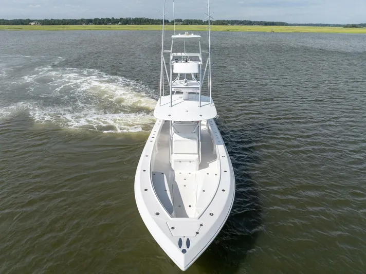 Bill Time Yacht Photos Pics 2016 Bahama 41 boat cruising on open water, aerial view.