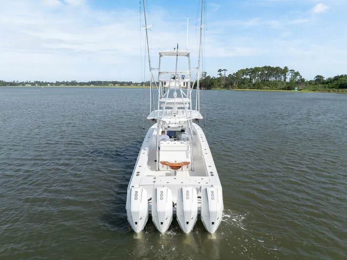 Bill Time Yacht Photos Pics 2016 Bahama 41 boat with four engines cruising on a calm lake.