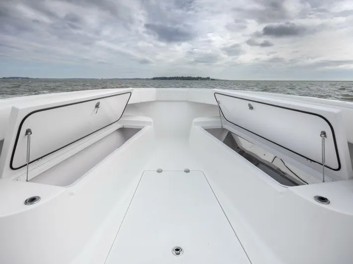 Bill Time Yacht Photos Pics 2016 Bahama 41 boat deck with open storage compartments on a cloudy day.