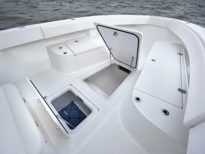 Bill Time Yacht Photos Pics 2016 Bahama 41 boat deck with open storage compartments on calm water.