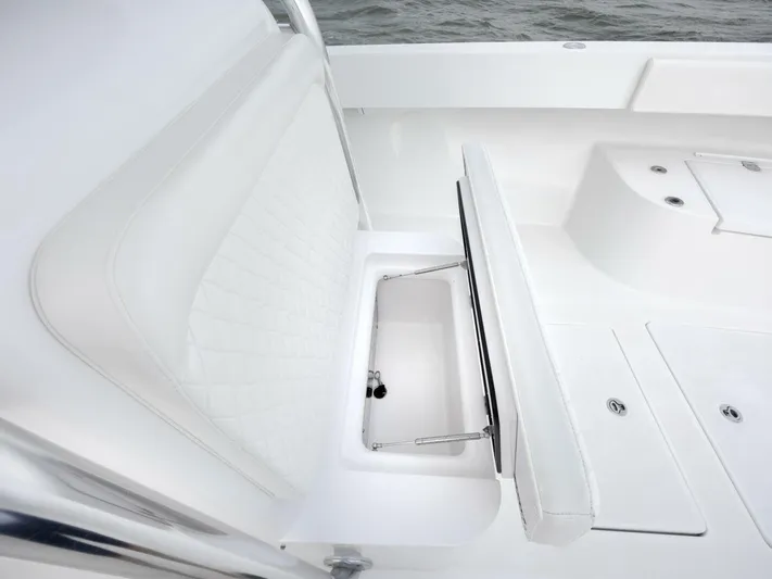 Bill Time Yacht Photos Pics 2016 Bahama 41 boat interior with white seating and storage compartment.