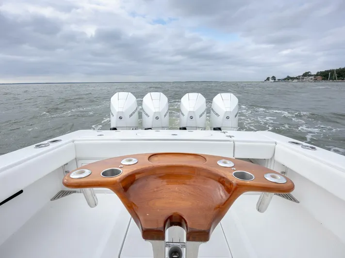 Bill Time Yacht Photos Pics 2016 Bahama 41 boat with four engines on open water, featuring a wooden fishing station.