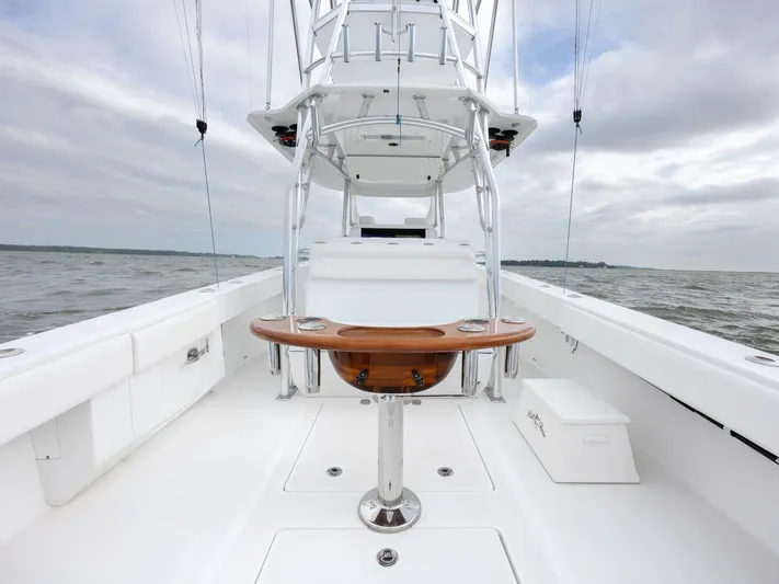 Bill Time Yacht Photos Pics 2016 Bahama 41 boat deck with tower, wooden table, and open sea view.