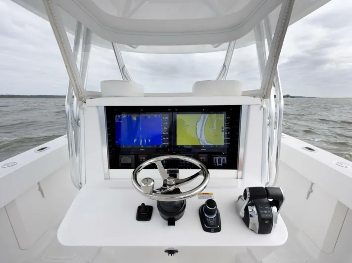 Bill Time Yacht Photos Pics 2016 Bahama 41 boat helm with navigation screens and controls on open water.