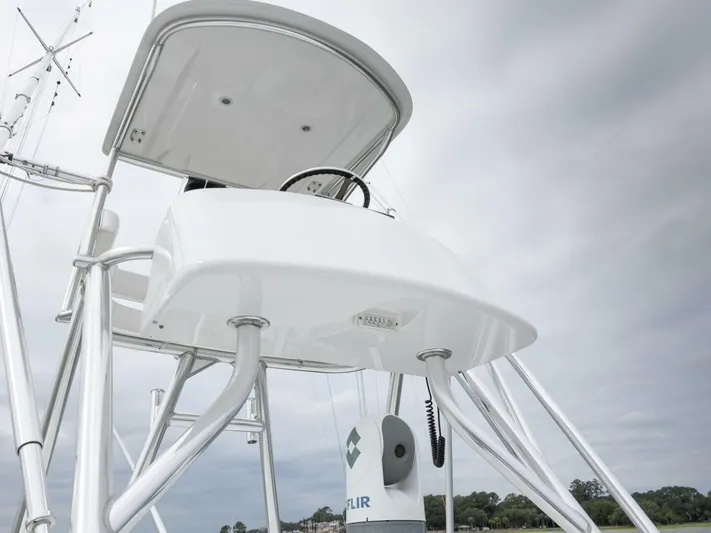 Bill Time Yacht Photos Pics Bahama 41 boat tower, 2016 model, with steering wheel and canopy against cloudy sky.