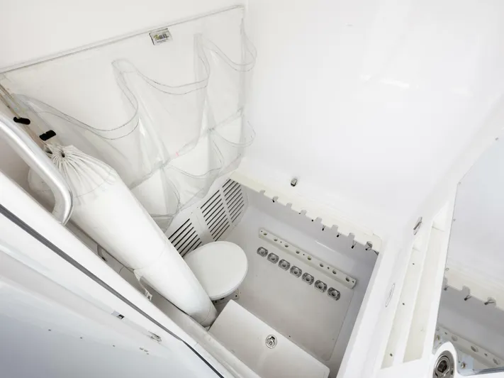 Bill Time Yacht Photos Pics Interior of 2016 Bahama 41 boat bathroom with white fixtures and storage.