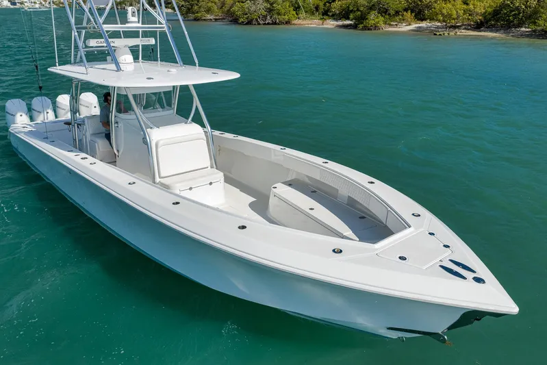 Bill Time Yacht Photos Pics 2016 Bahama 41 boat on turquoise water near lush shoreline.