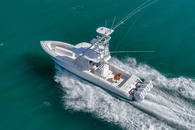 Bill Time Yacht Photos Pics Aerial view of 2016 Bahama 41 boat cruising on turquoise water.