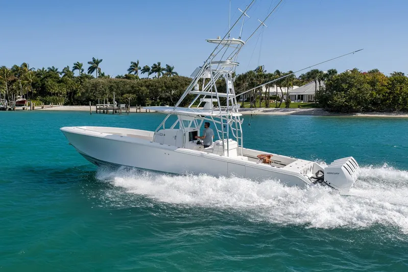 Bill Time Yacht Photos Pics 2016 Bahama 41 boat cruising on turquoise water near a tropical shoreline.