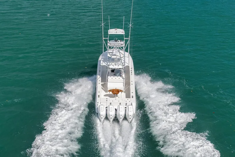Bill Time Yacht Photos Pics 2016 Bahama 41 boat cruising on clear turquoise water, aerial view.