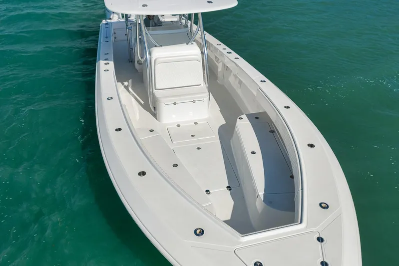 Bill Time Yacht Photos Pics 2016 Bahama 41 boat on clear turquoise water, showcasing sleek design and spacious deck.