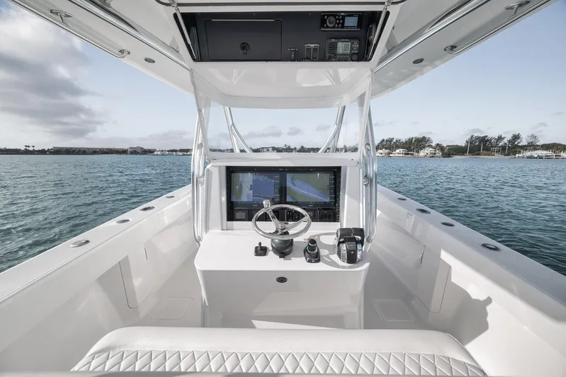 Bill Time Yacht Photos Pics 2016 Bahama 41 boat helm with navigation screens, steering wheel, and ocean view.