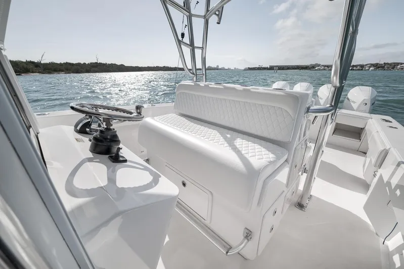 Bill Time Yacht Photos Pics 2016 Bahama 41 boat interior with white seating and steering wheel, overlooking calm waters.