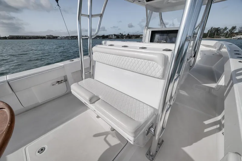 Bill Time Yacht Photos Pics 2016 Bahama 41 boat interior with cushioned seating and stainless steel frame on calm water.