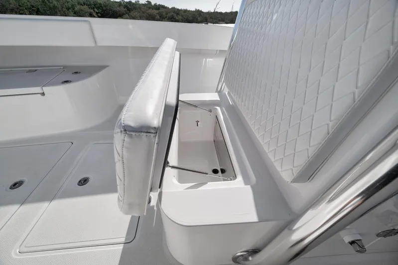 Bill Time Yacht Photos Pics 2016 Bahama 41 boat interior with open storage compartment and cushioned seating.