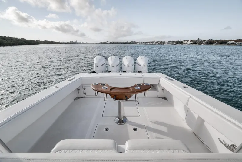 Bill Time Yacht Photos Pics 2016 Bahama 41 boat with quad engines on calm water, featuring a spacious deck.