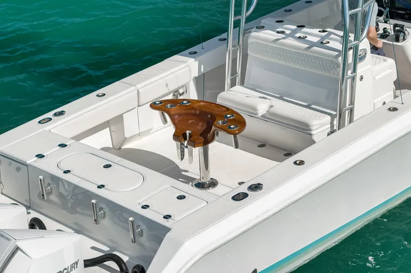 Bill Time Yacht Photos Pics 2016 Bahama 41 boat with white seating and wooden fishing chair on turquoise water.