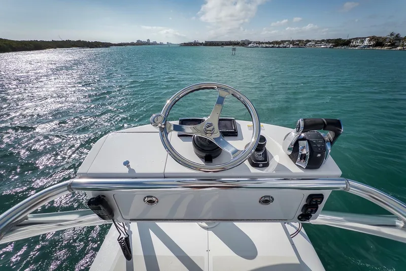 Bill Time Yacht Photos Pics 2016 Bahama 41 boat helm with ocean view, featuring steering wheel and controls.