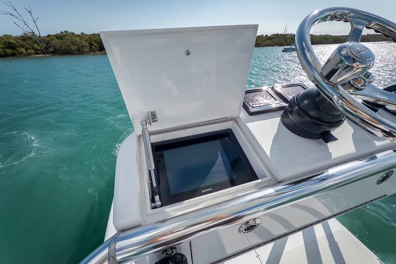 Bill Time Yacht Photos Pics 2016 Bahama 41 boat helm with Garmin display, steering wheel, and ocean view.