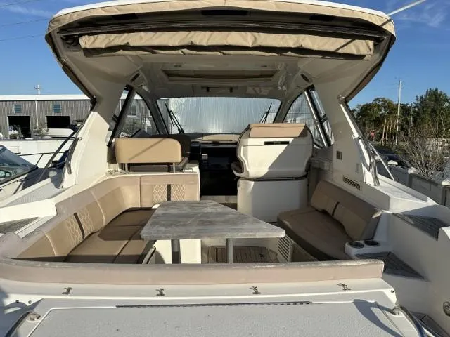  Yacht Photos Pics 2017 Sea Ray Sundancer 350 Coupe interior with seating and table, docked outdoors.
