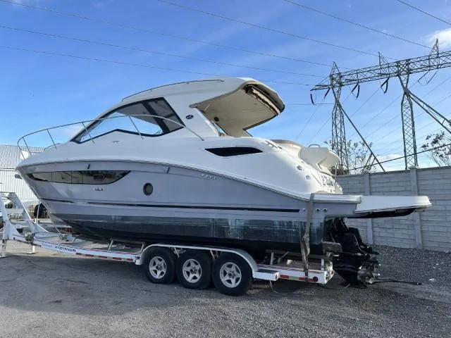  Yacht Photos Pics 2017 Sea Ray Sundancer 350 Coupe on trailer, parked outdoors under clear sky.