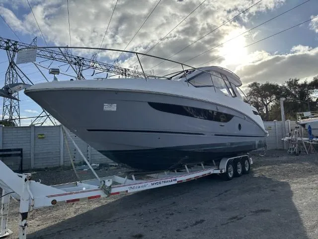  Yacht Photos Pics 2017 Sea Ray Sundancer 350 Coupe on trailer under cloudy sky.