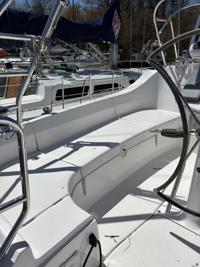 Lucky Dog Too Yacht Photos Pics 2008 Hunter 41 DS sailboat cockpit with white seating and steering wheel.
