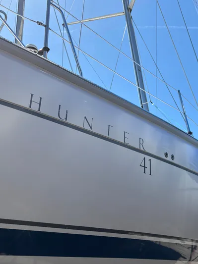 Lucky Dog Too Yacht Photos Pics 2008 Hunter 41 DS sailboat hull with rigging against blue sky.