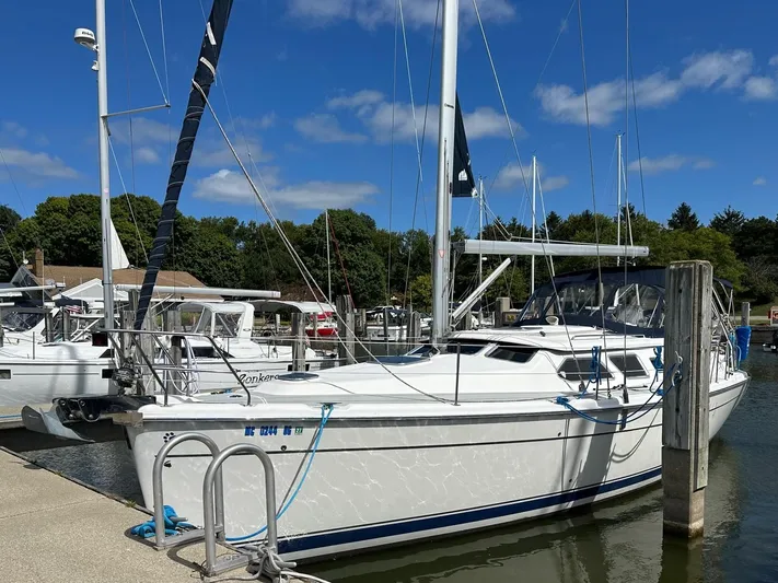 Lucky Dog Too Yacht Photos Pics 2008 Hunter 41 DS sailboat docked at marina under clear blue sky.