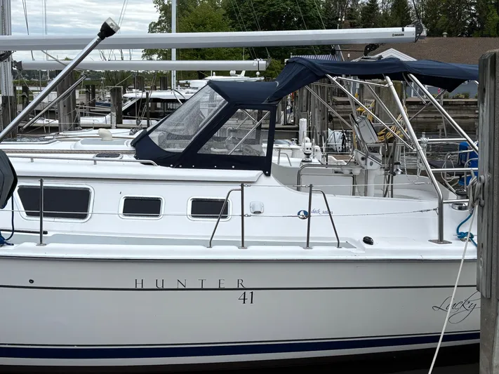 Lucky Dog Too Yacht Photos Pics 2008 Hunter 41 DS sailboat docked at marina with blue canopy.