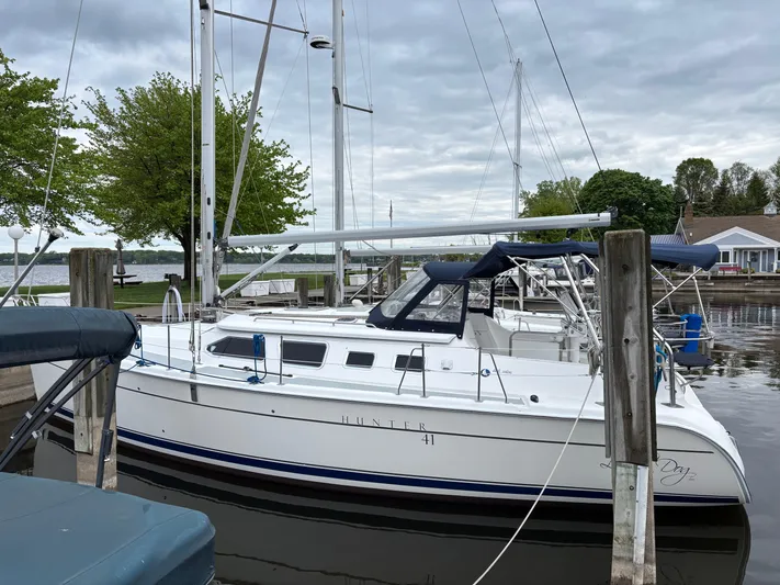 Lucky Dog Too Yacht Photos Pics 2008 Hunter 41 DS sailboat docked at a marina under cloudy skies.