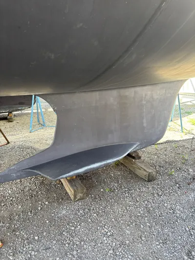 Lucky Dog Too Yacht Photos Pics Keel of a 2008 Hunter 41 DS sailboat on a gravel surface.