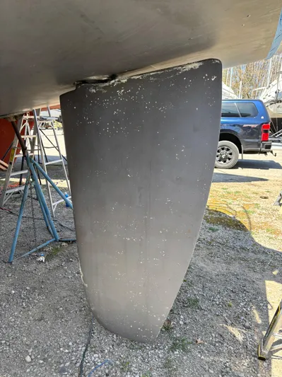 Lucky Dog Too Yacht Photos Pics Keel of a 2008 Hunter 41 DS sailboat on a gravel surface.