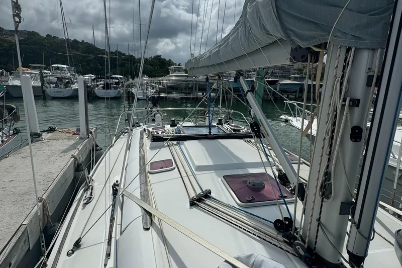 Pelican Pat Yacht Photos Pics Sailboat Jeanneau Sun Odyssey 42i, 2010 model, docked at marina under cloudy sky.