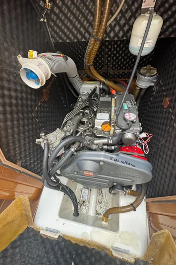 Pelican Pat Yacht Photos Pics Engine compartment of 2010 Jeanneau Sun Odyssey 42i sailboat, showcasing detailed mechanical components.