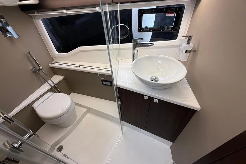  Yacht Photos Pics Luxurious bathroom in 2024 Galeon 410 HTC yacht with modern fixtures and elegant design.