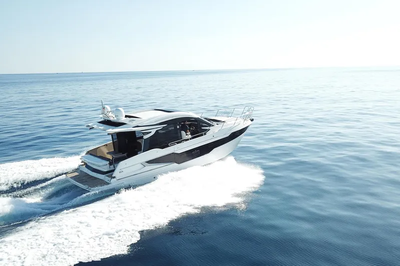  Yacht Photos Pics 2024 Galeon 410 HTC yacht cruising on open water, showcasing sleek design and performance.